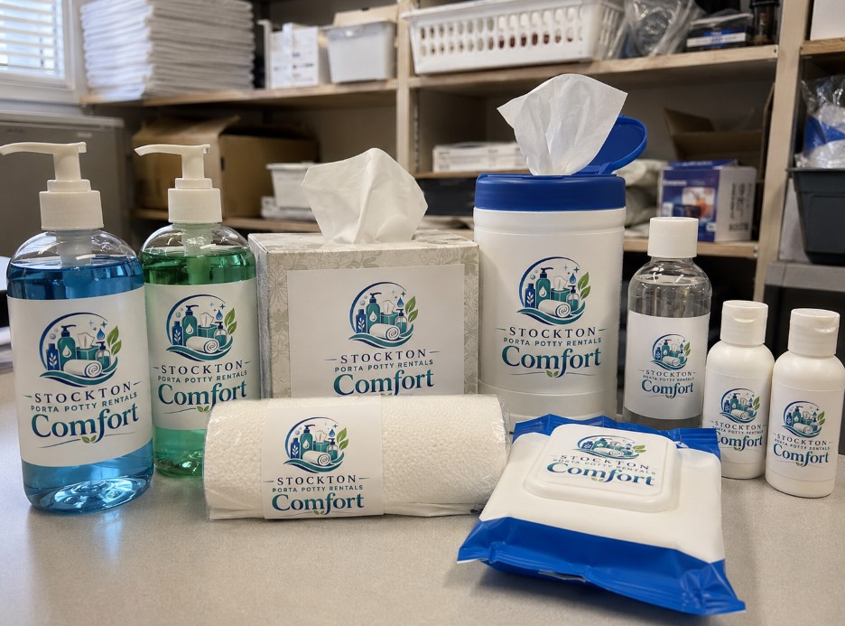 Stockton Porta Potty Rentals Comfort branded toiletries — hand soap, sanitizing wipes, tissues, towel roll, lotion and travel-size bottles